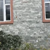 Gray split rock veneer with uniform chiseled relief texture, weatherproof exterior stone cladding for villa outdoor facades