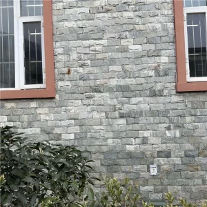 Gray split rock veneer with uniform chiseled relief texture, weatherproof exterior stone cladding for villa outdoor facades