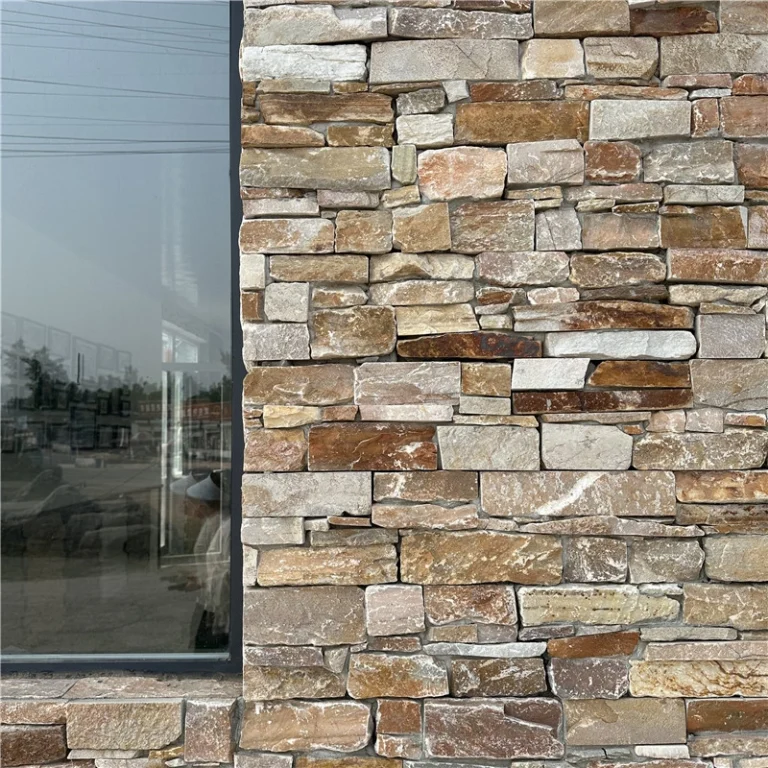 Warm rust-toned pre-assembled stacked ledger stone strips, rough split face natural veneer with rustic organic texture for residential exterior accent walls & fireplace surrounds