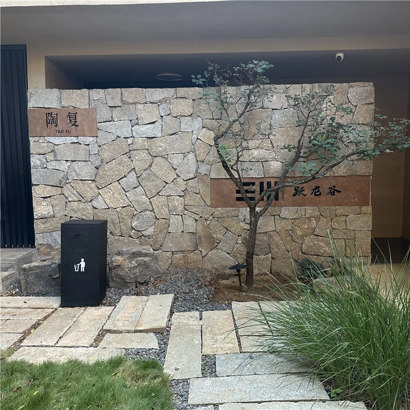 Rust tone irregular stone cladding for entrance feature wall