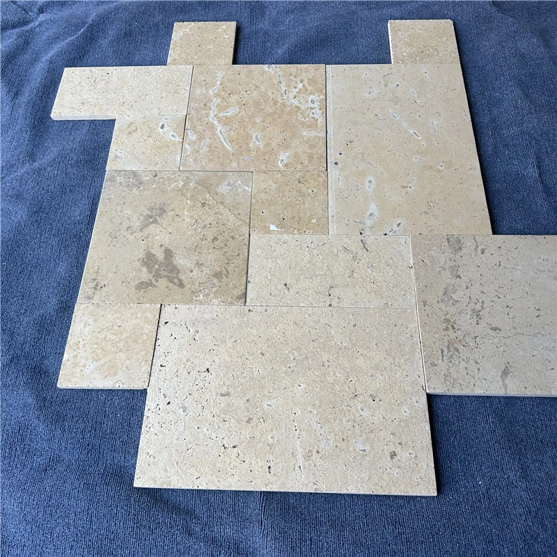 Loose laid tumbled beige limestone slabs