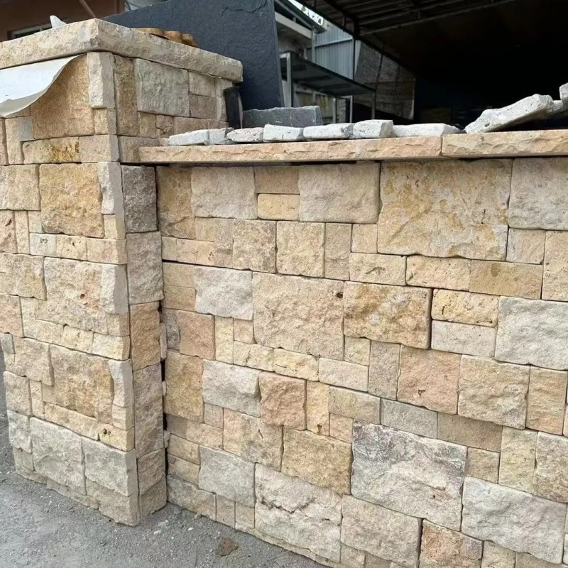 Cream vintage ledger stone veneer with rough split edges, castle-style stacked stone cladding for residential courtyard retaining walls and outdoor facade feature walls