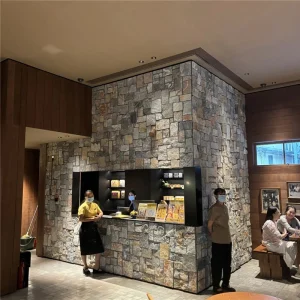 Irregular loose natural-face fieldstone mosaic veneer with grey, blue and rust mineral tones, indoor-outdoor decorative stone cladding for cafe, villa patio, garden and lobby accent walls
