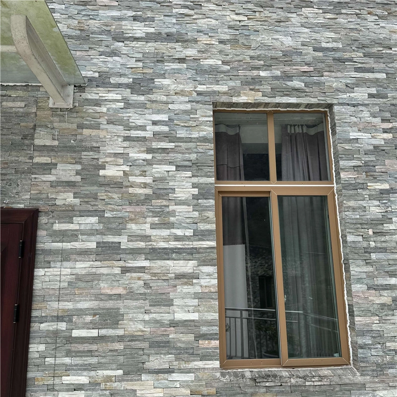 Thin linear pre-glued stacked stone veneer, split face neutral grey ledge stone cladding for modern residential exterior facade