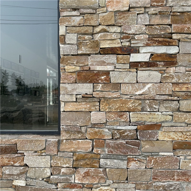 Rust yellow rustic ledgestone veneer, layered stacked stone with rough natural split edges and earth rust yellow mineral veins for vintage villa exterior facade