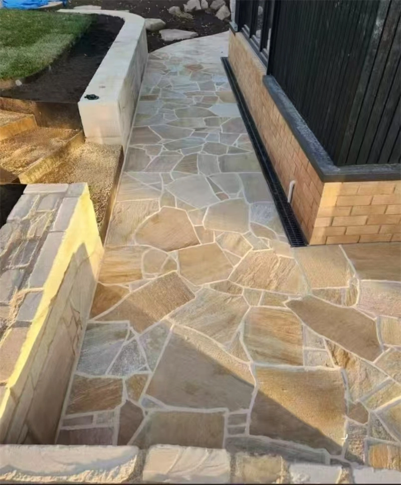 Residential living room flooring install, warm cream fossil limestone pavers with natural mineral veining, rustic calcareous sedimentary stone for full indoor floor paving