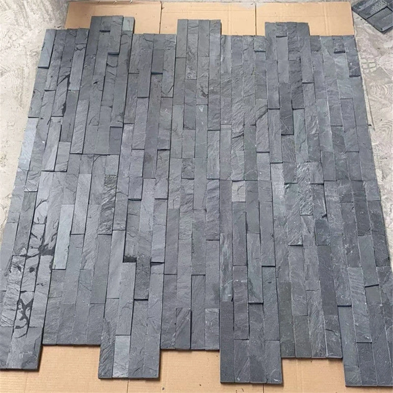 Natural black quartzite stacked stone ledger panels laid flat for display