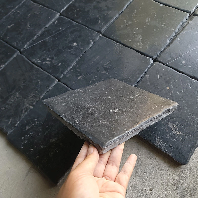 Natural Black Limestone floor tile sample hand held