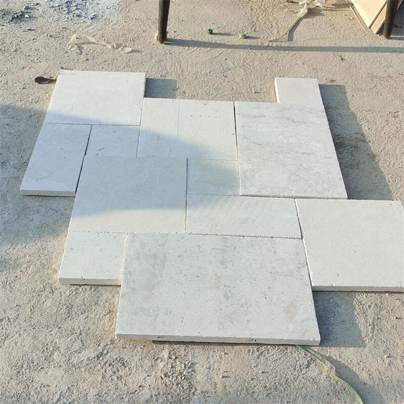 Honed off‑white limestone paving slabs laid for outdoor courtyard flooring project