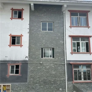 Green slate mushroom-faced stone cladding on residential building exterior wall