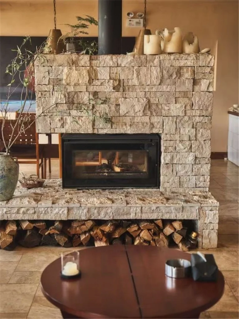 Beige limestone exterior wall cladding for indoor fireplace surround feature wall
