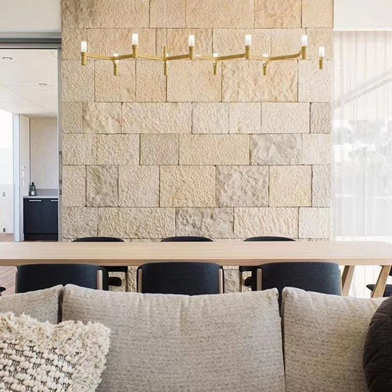 Beige limestone exterior wall cladding used as indoor dining room feature accent wall
