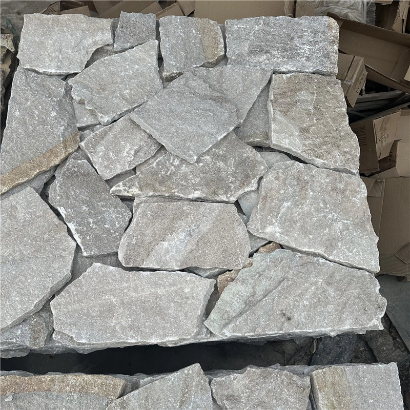 Loose natural white sandstone random stone pieces before installation