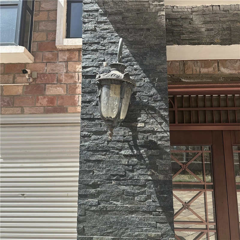 Black quartzite ledger stone applied on villa exterior facade wall cladding