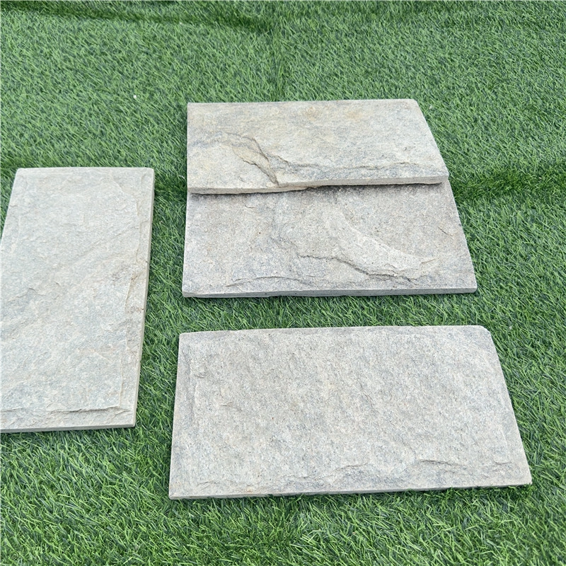 Green slate mushroom‑faced stone sample slabs displayed on green grass