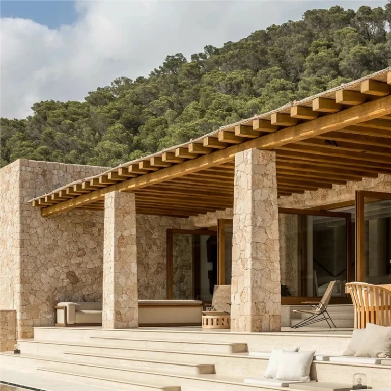 Luxury mediterranean villa exterior with beige crazy paving stone wall and pillars, rustic outdoor architecture