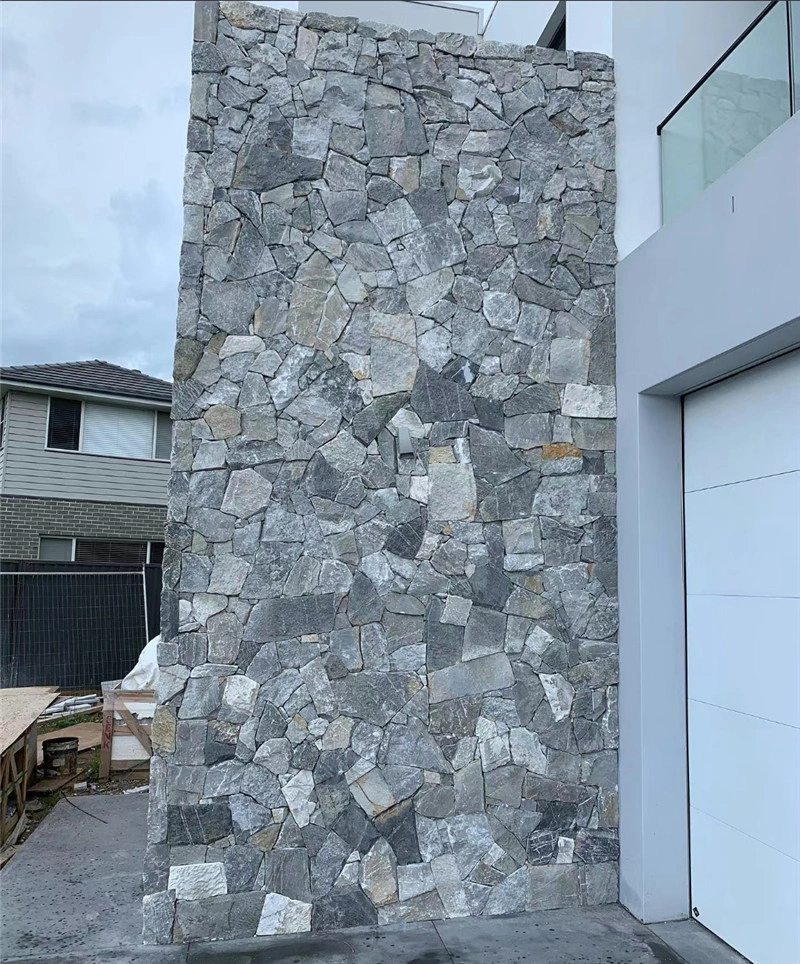 Modern house exterior feature wall with grey‑white irregular crazy paving stone cladding, villa facade natural stone