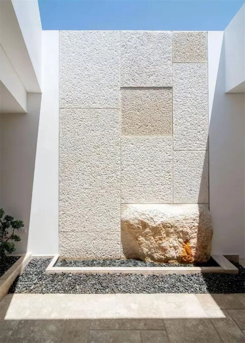 Off‑white limestone ledger stone feature wall for villa entrance exterior facade