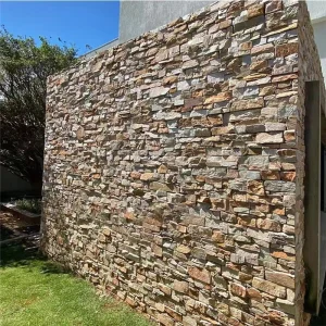 **** `Rust slate stacked stone veneer installed on garden retaining wall`