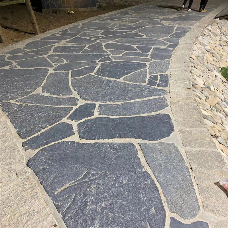 Black slate crazy paving curved outdoor patio walkway