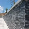 Black Stacked Stone Wall Cladding applied on outdoor landscape retaining wall