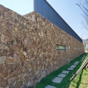 Rusty yellow crazy paving stone for exterior long garden boundary wall cladding