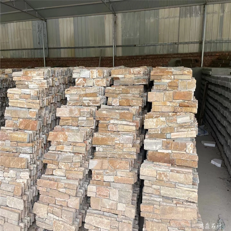 Natural multicolor rust slate ledger stone stock piles inside factory warehouse