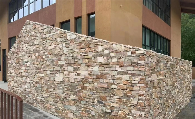 Multicolor rust slate ledger stone stacked veneer applied on modern building exterior wall
