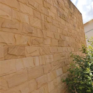 Yellow Sandstone Mushroom Stone installed on outdoor garden boundary wall