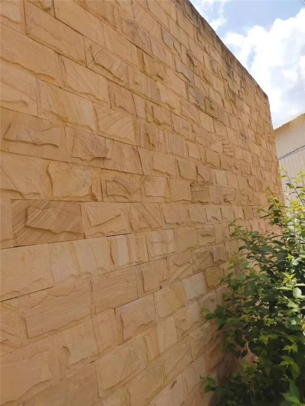 Yellow Sandstone Mushroom Stone installed on outdoor garden boundary wall