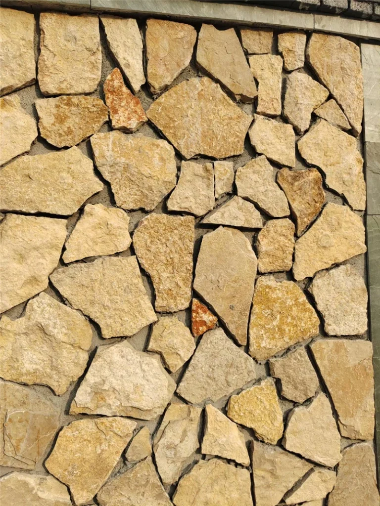 Close‑up view of golden rust slate crazy paving exterior wall cladding
