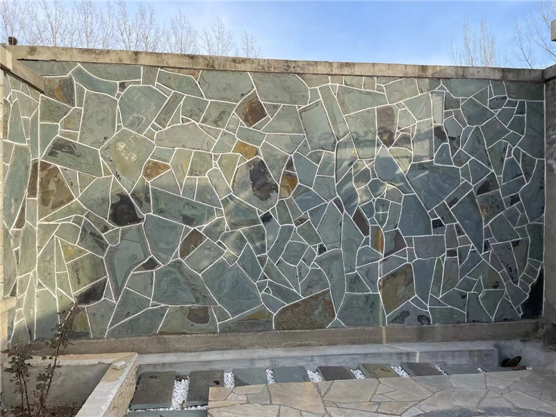 Green‑grey slate crazy paving for garden boundary wall