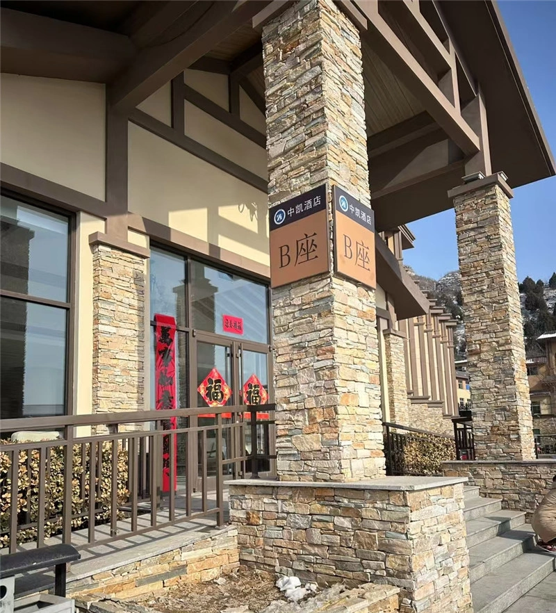 Yellow rust stacked ledger stone cladding on building entrance pillars natural slate facade