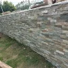 Mixed Grey Stacked Ledger Stone Finished Retaining Wall In Residential Garden