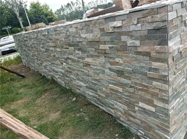 Mixed Grey Stacked Ledger Stone Finished Retaining Wall In Residential Garden