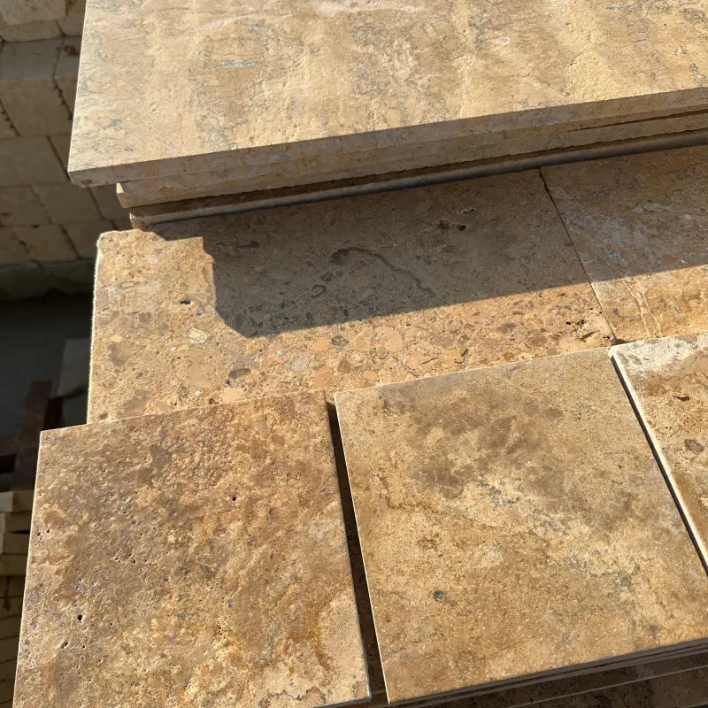 Walnut Brown Limestone Tumbled Tile stacked in stock