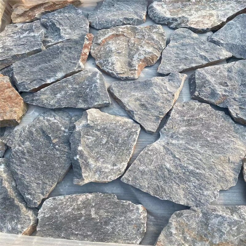 Grey crazy paving stone for villas, dark grey irregular crazy paving raw stone pieces close-up with natural texture