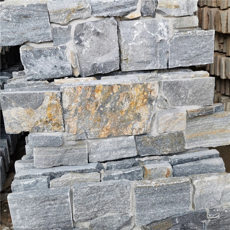 Light blue stacked stone exterior wall cladding, rough natural ledger stone stock pile close‑up