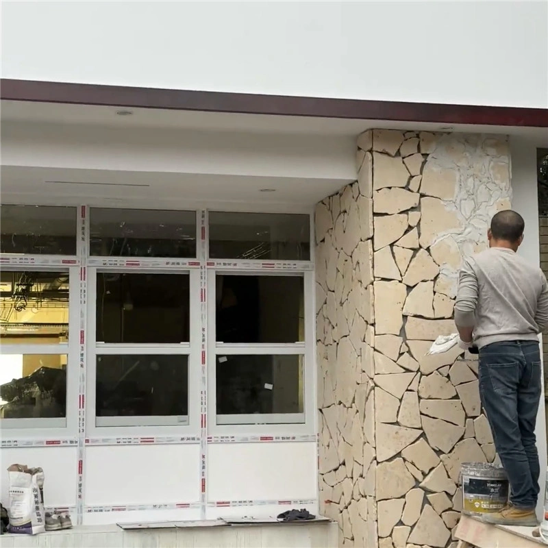 Yellow Limestone Crazy Paving exterior wall cladding on residential building real construction site