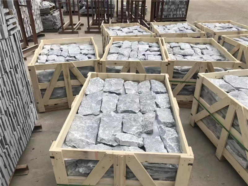 Grey slate ledger panels packed in wooden crates for export