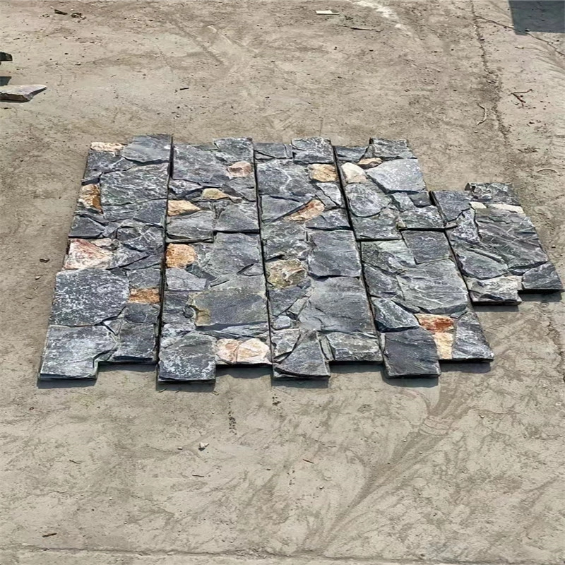 Light blue stacked stone exterior wall cladding, mesh‑backed ledger stone panels laid on ground