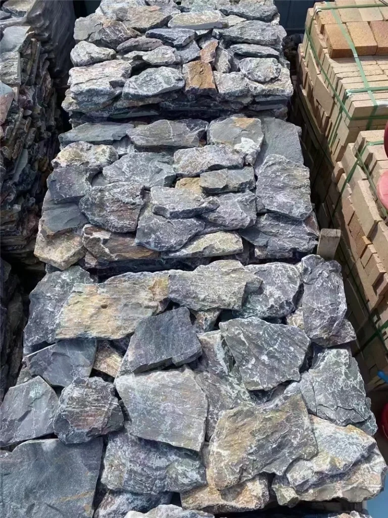 Dusky Purple Crazy Paving stone pieces stacked in a factory warehouse