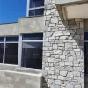 Grey slate ledger panel cladding on residential exterior building wall