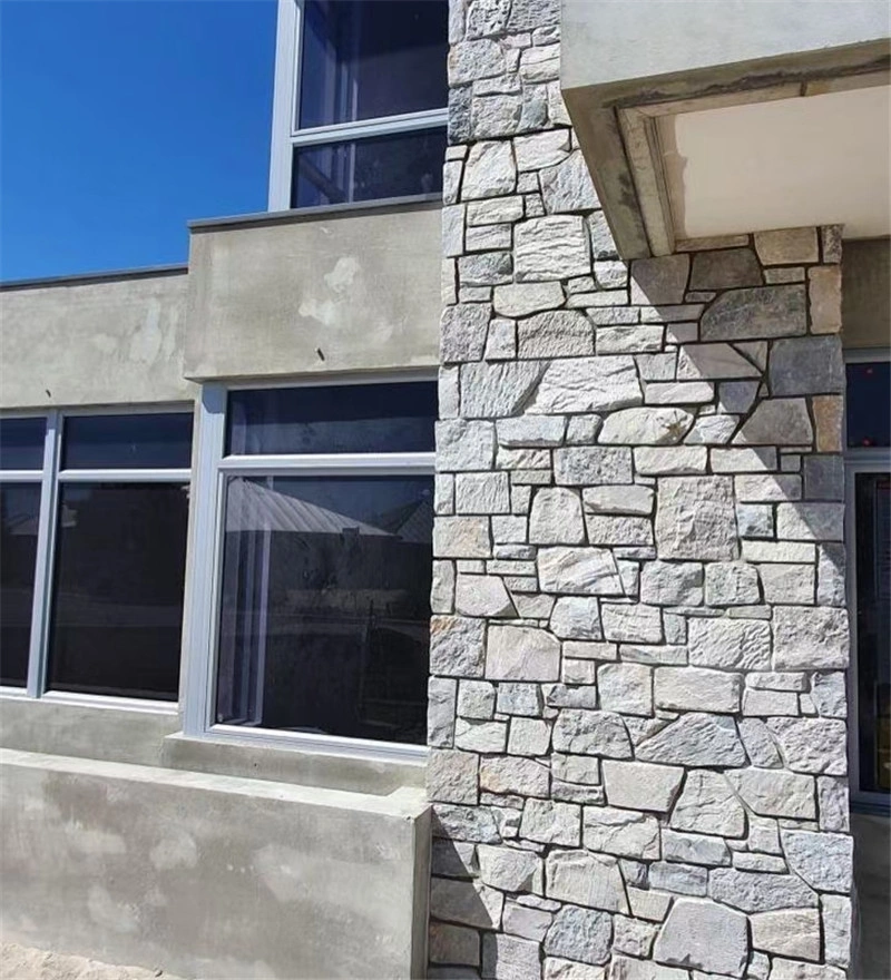 Grey slate ledger stone cladding applied on residential exterior building wall