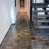 Black limestone with gold veins, natural stone flooring in an interior hallway