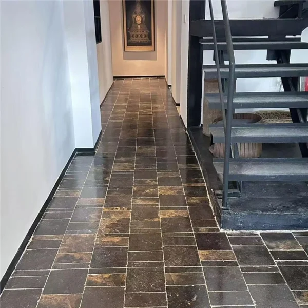 Black limestone with gold veins, natural stone flooring in an interior hallway