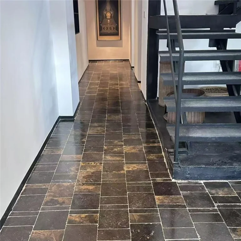 Black limestone with gold veins, natural stone flooring in an interior hallway