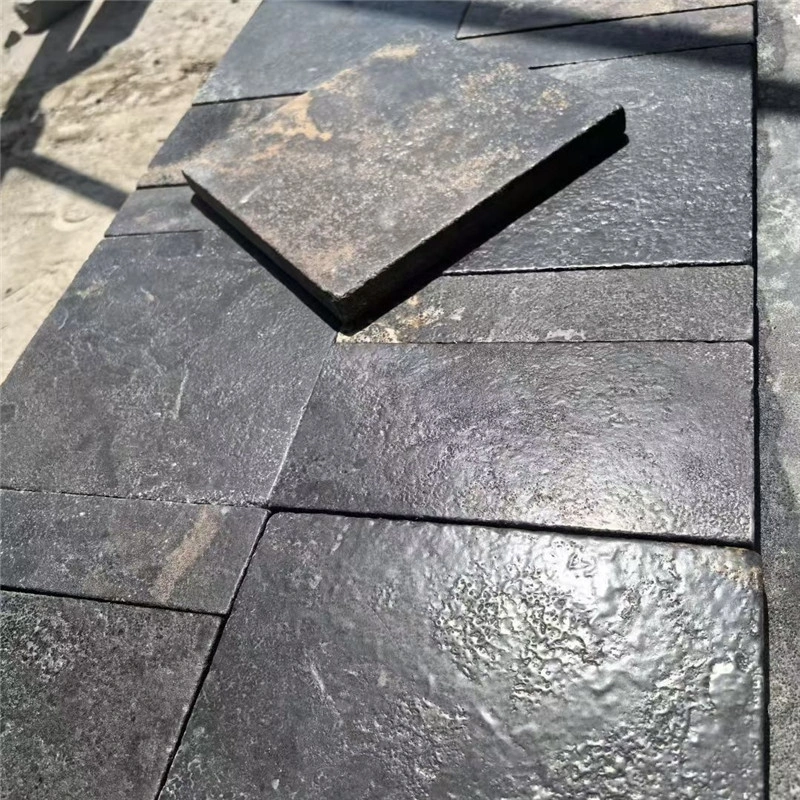 Black limestone with gold veins rough natural surface, stone sample close-up