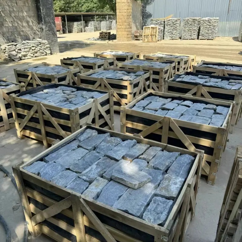 Light blue stacked stone exterior wall cladding, export wooden crates bulk stock at factory yard