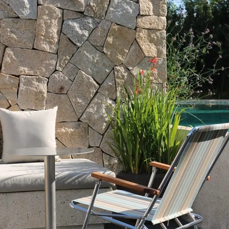 Light Yellow Random Rubble Stone, natural rubble stone wall beside swimming pool outdoor patio